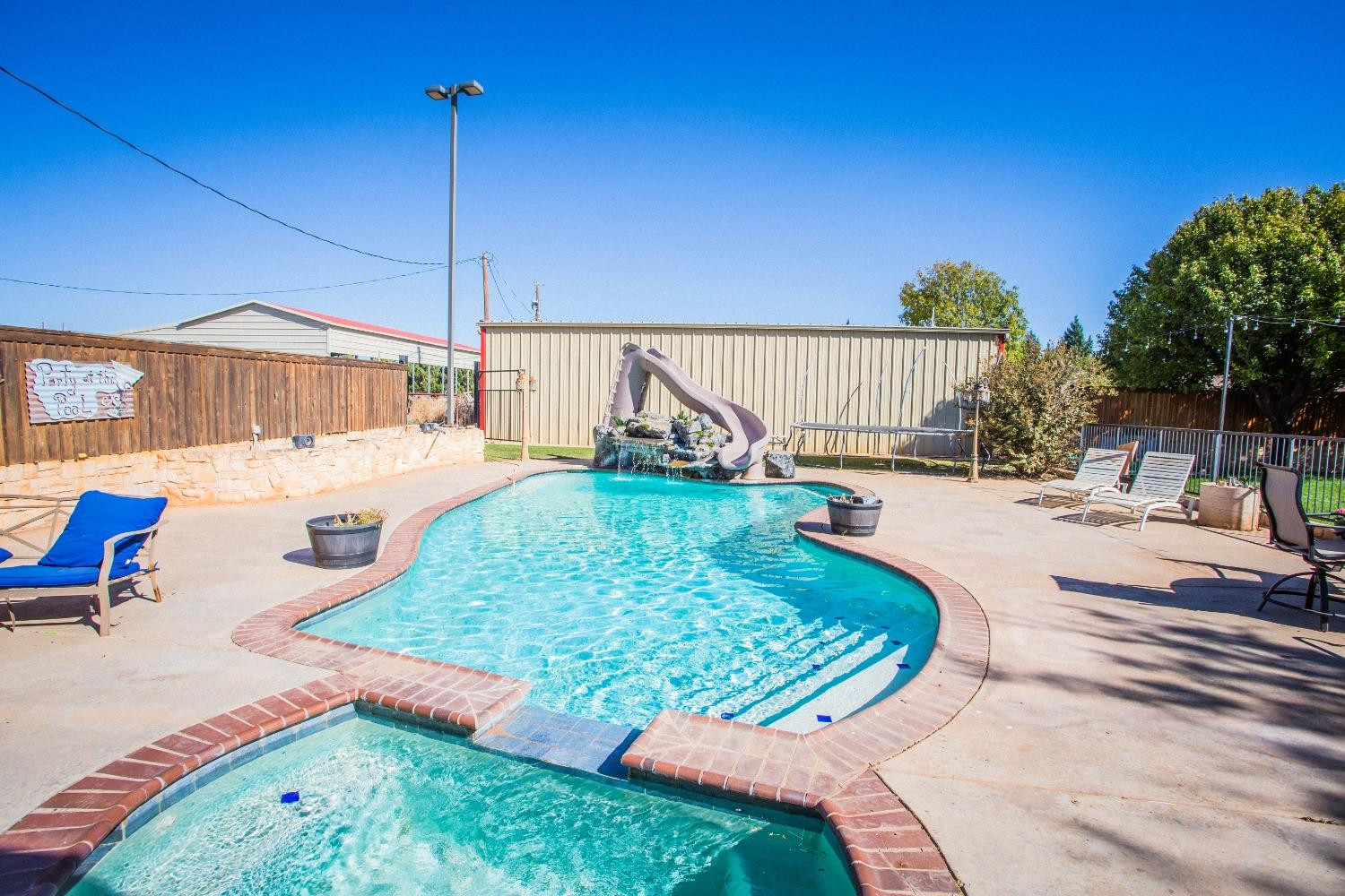7516 66th Street Lubbock, TX 79407 - Photo 40 of 50 a view of a swimming pool with a patio