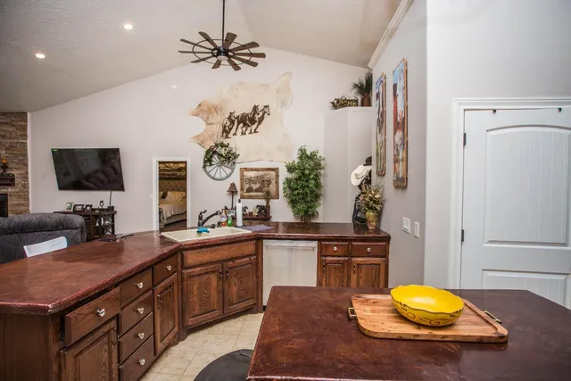 a kitchen with a sink cabinets and wooden floor
