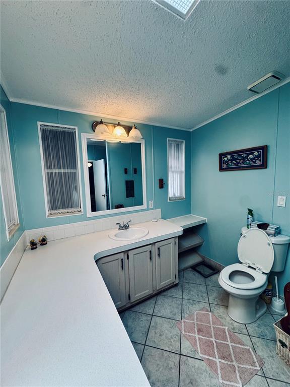 4339 Mackeral Circle Edgewater, FL 32141 - Photo 5 of 33 a bathroom with a double vanity sink mirror and toilet