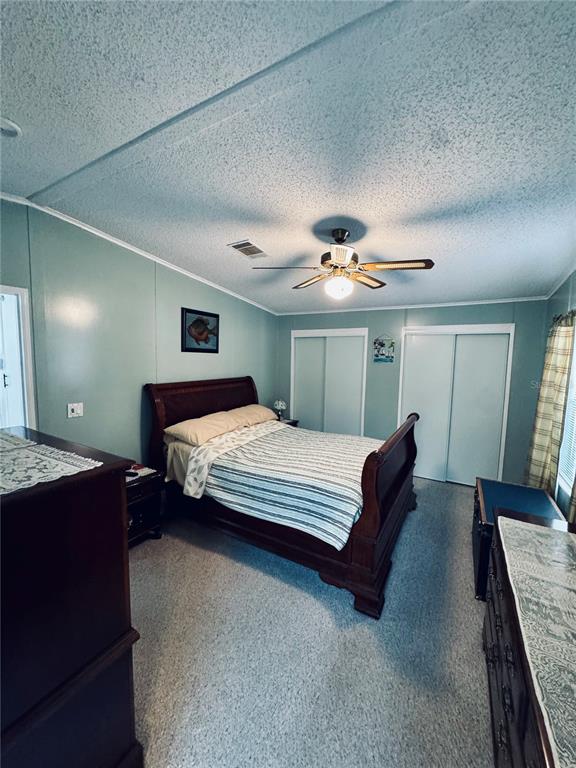 4339 Mackeral Circle Edgewater, FL 32141 - Photo 8 of 33 a bedroom with a bed and lamp with view