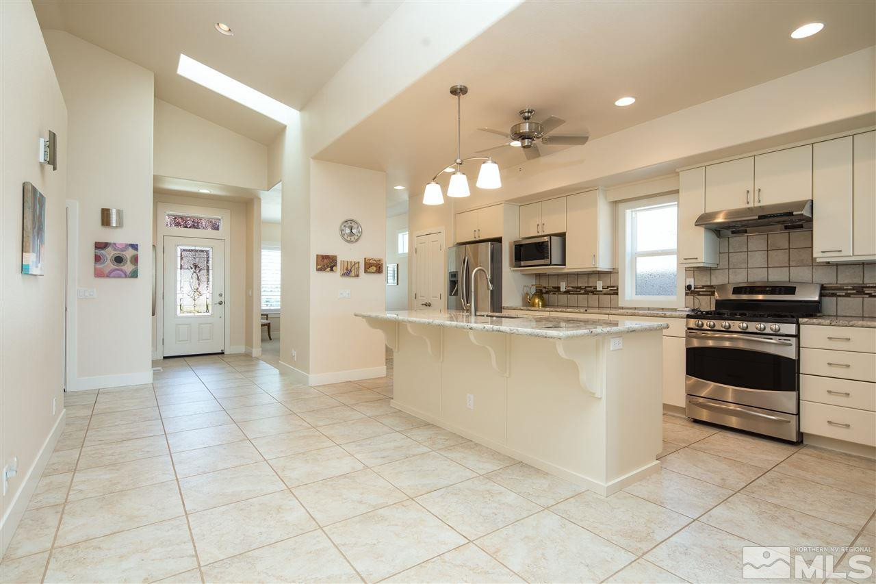 2769 Mountain Springs Road Reno, NV 89519 - Photo 2 of 25 a kitchen with granite countertop a stove top oven and cabinets