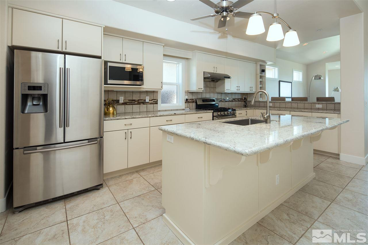 2769 Mountain Springs Road Reno, NV 89519 - Photo 3 of 25 a kitchen with stainless steel appliances a refrigerator sink and microwave