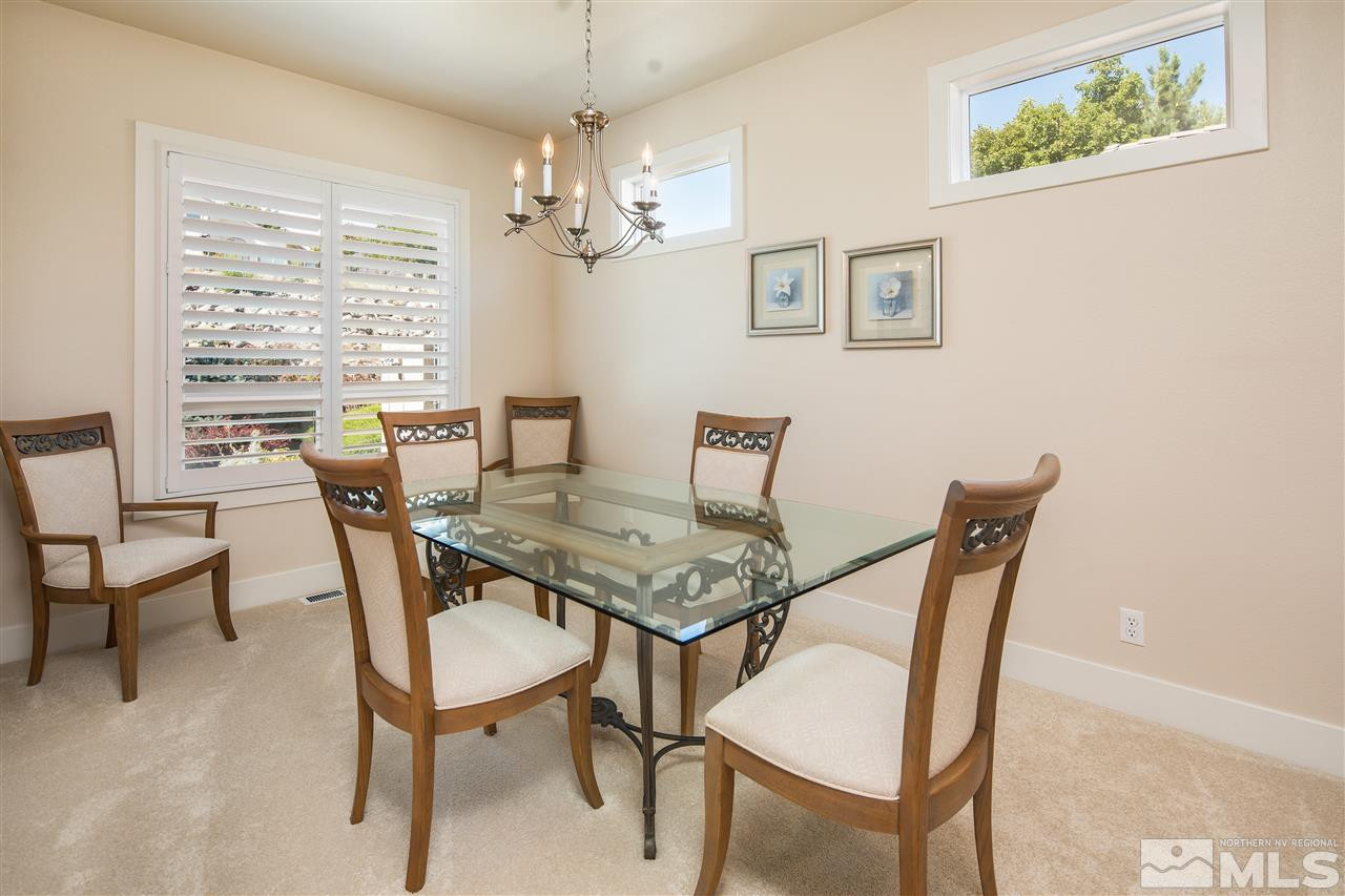 2769 Mountain Springs Road Reno, NV 89519 - Photo 4 of 25 a view of a dining room with furniture a chandelier and wooden floor