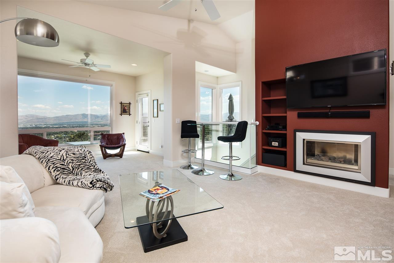 2769 Mountain Springs Road Reno, NV 89519 - Photo 6 of 25 a living room with furniture a flat screen tv and a fireplace