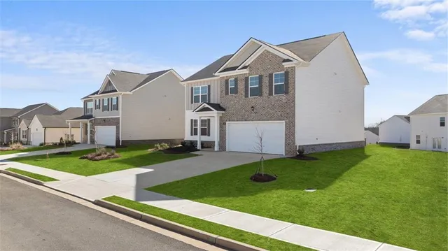 a front view of house with yard and green space