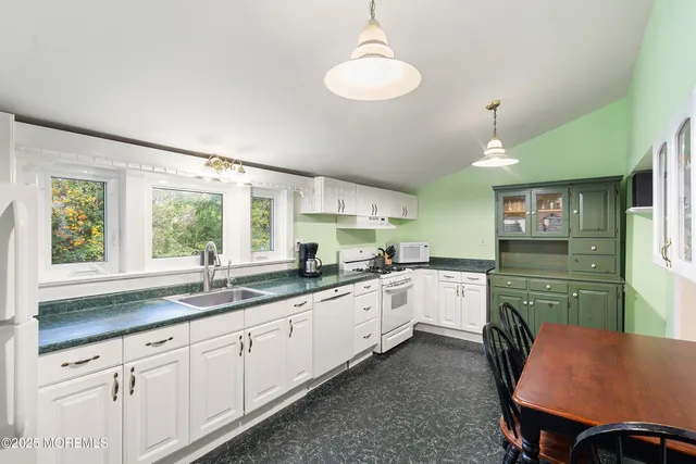 a bathroom with a sink mirror and toilet