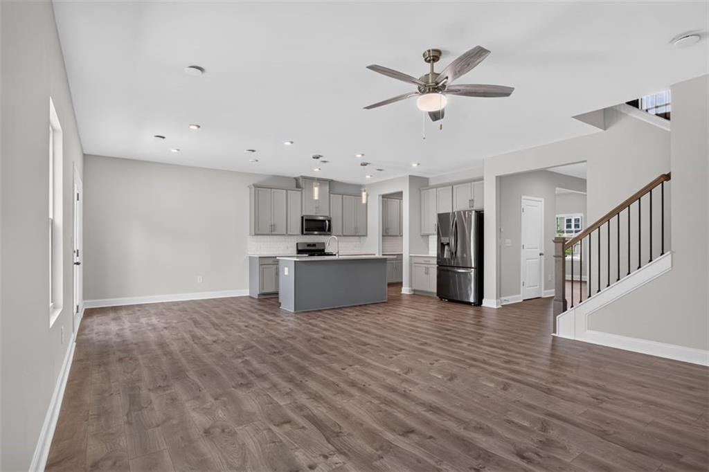 107 Ledgemont Way Acworth, GA 30101 - Photo 16 of 57 a view of a kitchen with wooden floor and a ceiling fan