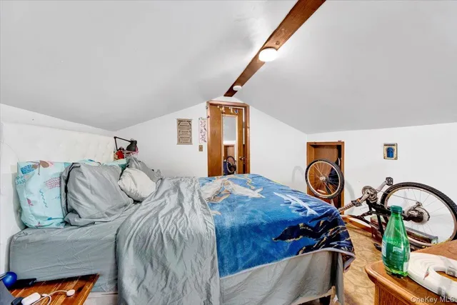 a bedroom with a bed and a dresser in it