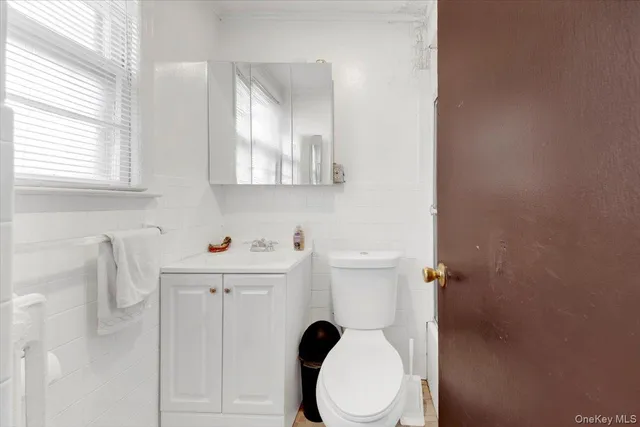 a white toilet sitting next to a bathroom sink