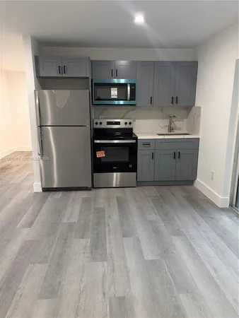 a kitchen with stainless steel appliances a refrigerator and a stove top oven