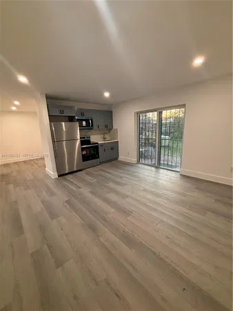 a view of a livingroom with furniture and staircase
