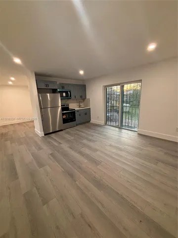 a view of a livingroom with furniture and staircase