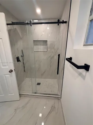 a bathroom with a glass door shower