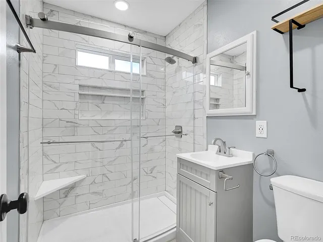 a bathroom with a sink toilet and shower