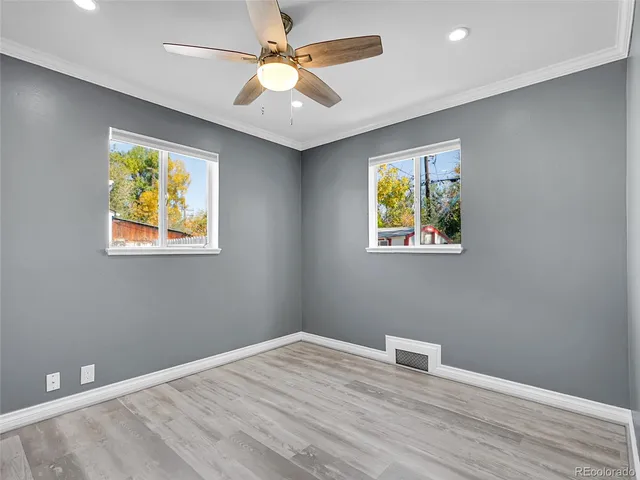 a view of room with window and wooden floor