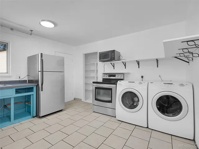 a utility room with sink dryer and washer