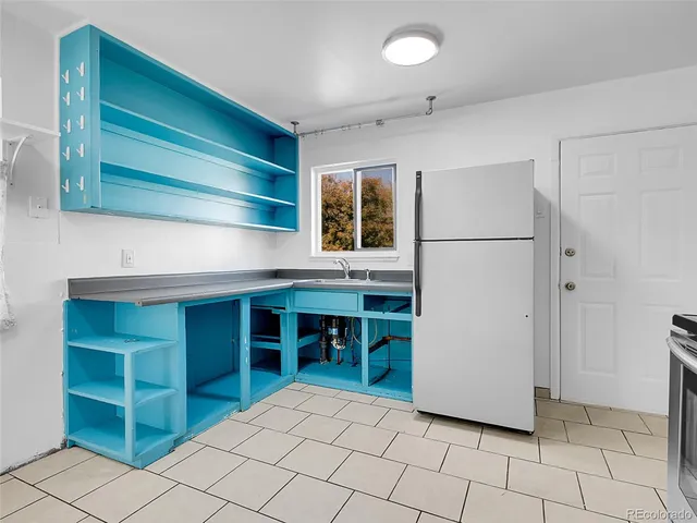 a kitchen with a cabinets and a refrigerator