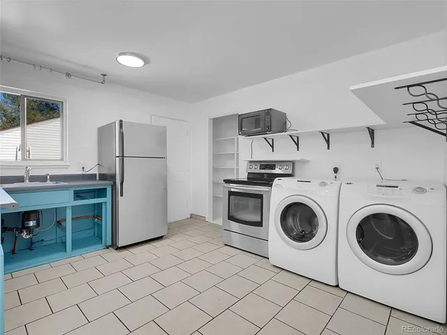 a utility room with sink dryer and washer
