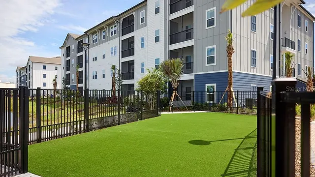 a view of a building with a backyard