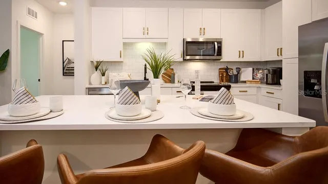 a kitchen with a dining table and chairs