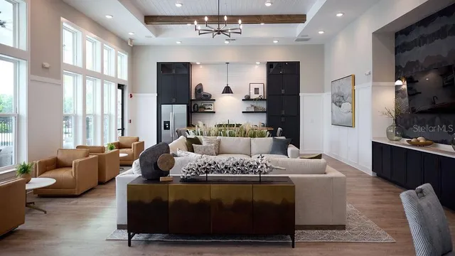 a living room with furniture fireplace and a large window