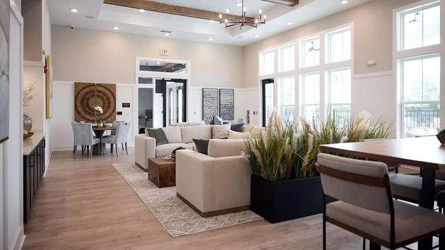 a living room with furniture a large window and a fireplace