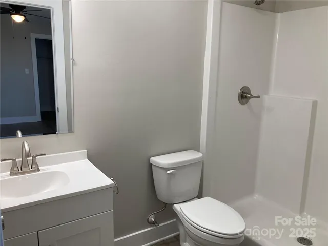 a white toilet sitting next to a bathroom sink