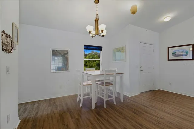 a view of a dining room with furniture wooden floor and a chandelier
