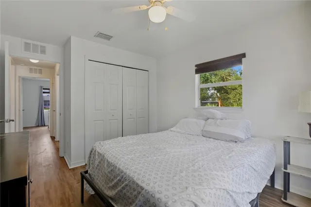 a bedroom with a bed and a painting on the wall