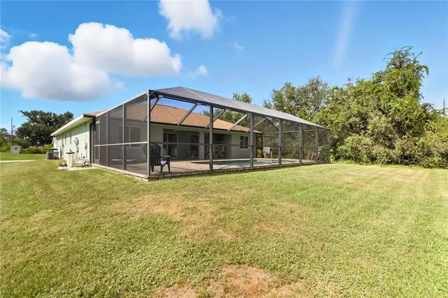 a view of a house with a yard and sitting area