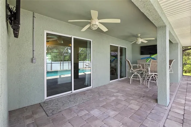 a view of a livingroom with a flat screen tv and outdoor space