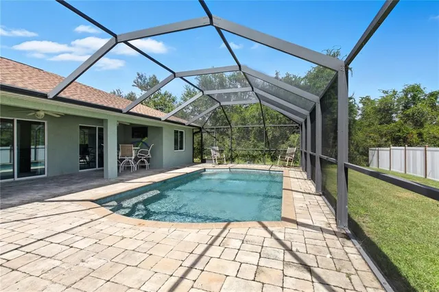 a view of a porch with a table and chairs