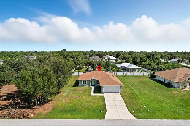 an aerial view of residential houses with outdoor space