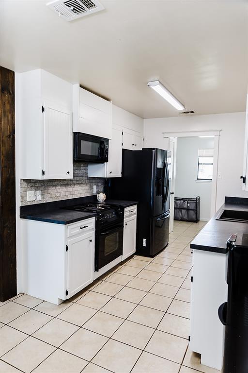 2010 Old Calf Creek Road Brady, TX 76825 - Photo 13 of 33 a kitchen with granite countertop a refrigerator and a stove top oven