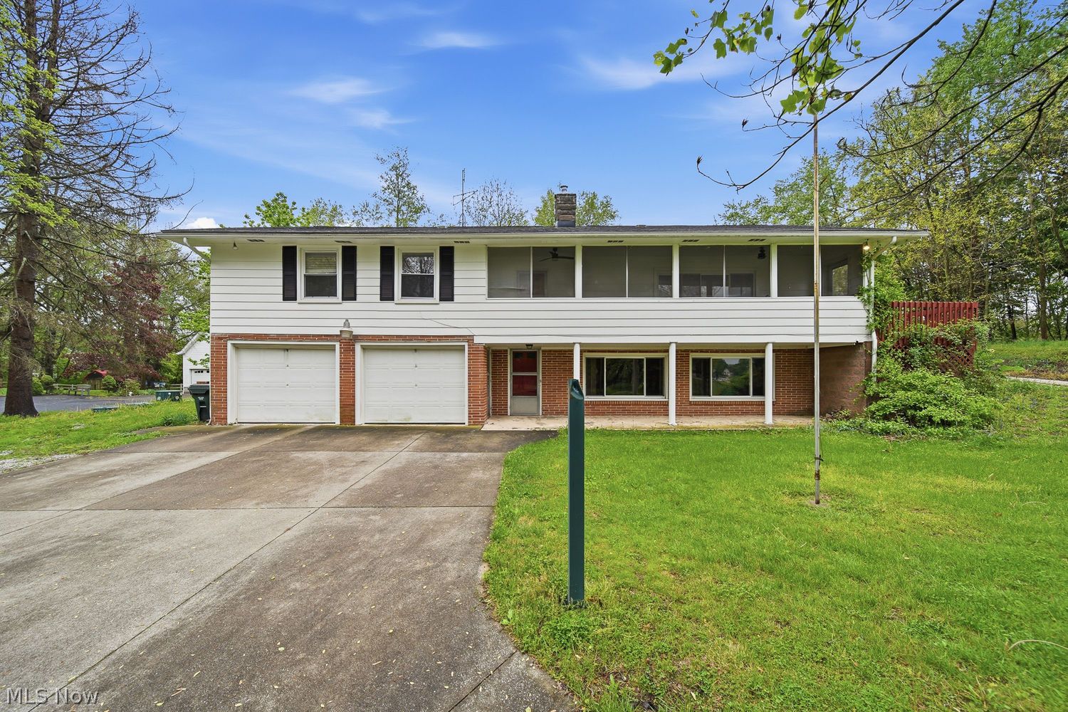 1556 Koons Road North Canton, OH 44720 - Photo 1 of 30 Front of home with screen-in Sunroom and covered patio
