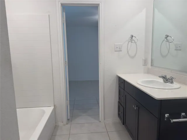 a bathroom with a sink vanity mirror and toilet