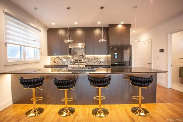 a front view of a building with a garden and plants