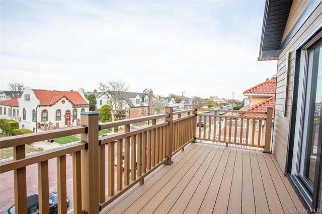 a view of an empty room with wooden floor and closet