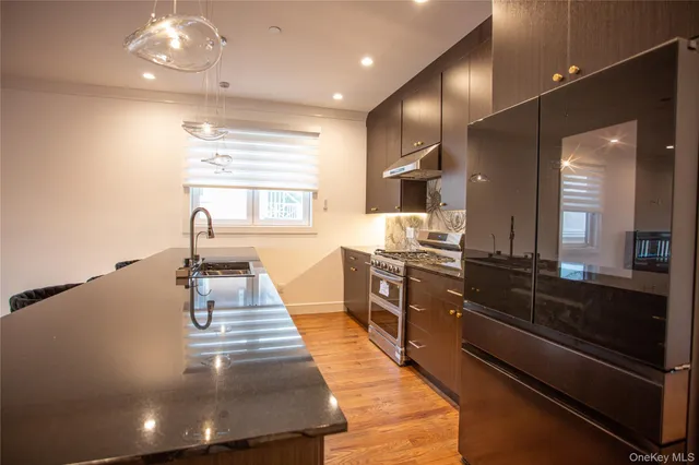 a view of empty room with wooden floor and fireplace