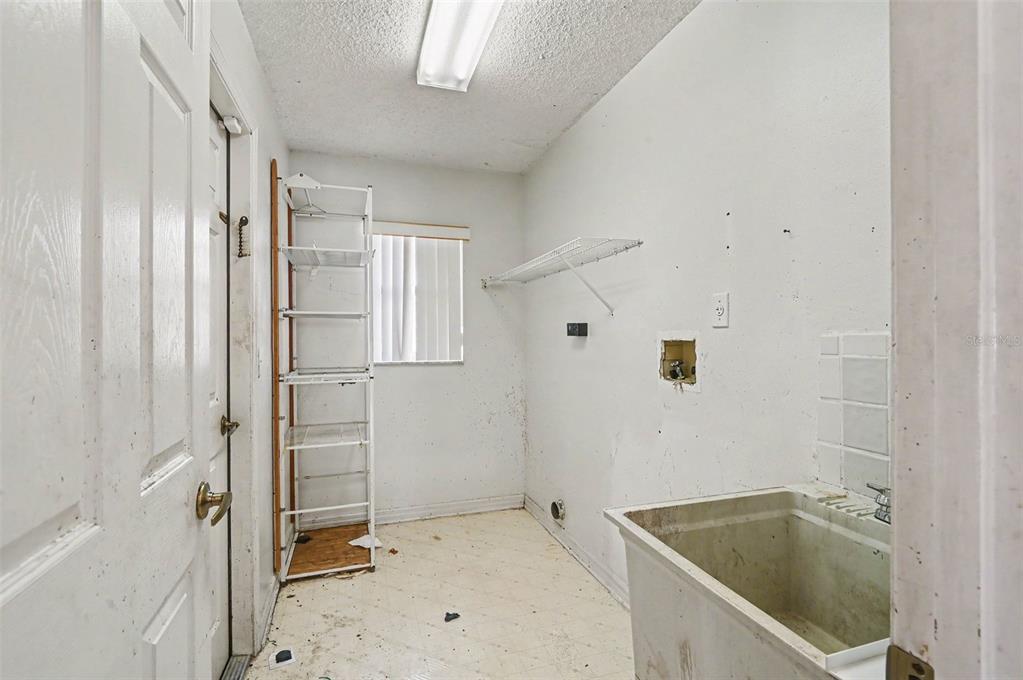 4716 Spaniel Street Orlando, FL 32818 - Photo 18 of 27 a bathroom with a tub a sink and a shower