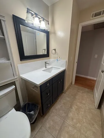 a bathroom with a sink vanity and mirror