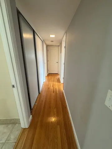 a view of hallway with wooden floor