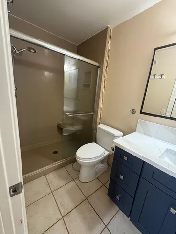 a bathroom with a toilet a sink and shower