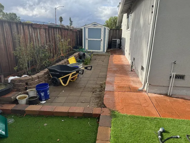 a view of a patio with table and chairs with wooden floor and fence