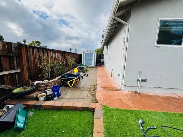 a view of a backyard with potted plants