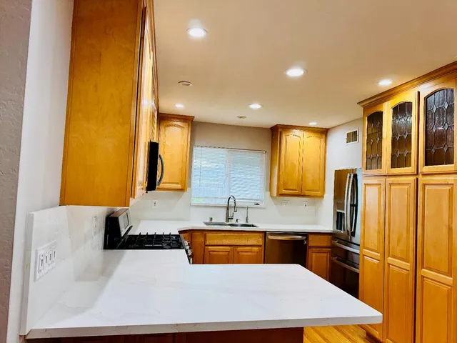 a kitchen with stainless steel appliances a sink and a refrigerator