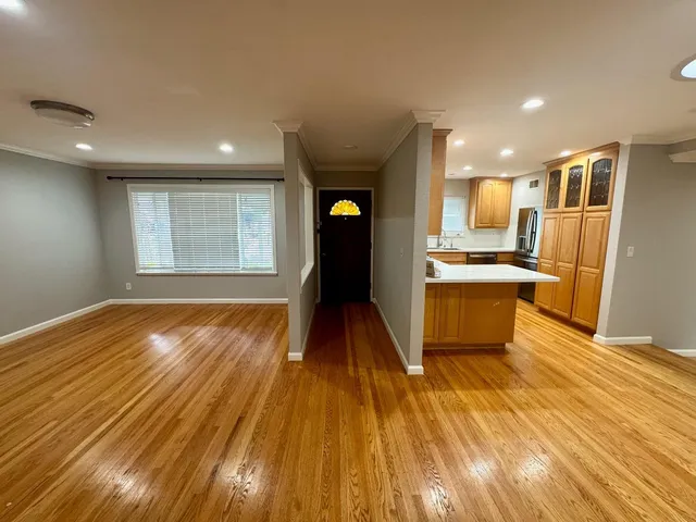 a view of a living room and wooden floor