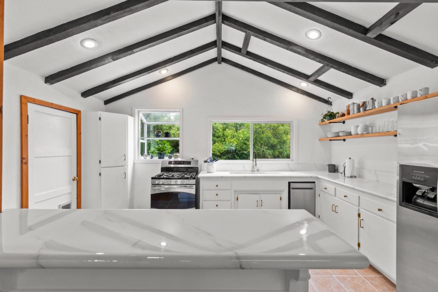 210 Madrona Way Ben Lomond, CA 95005 - Photo 18 of 56 a kitchen with a stove a sink and white cabinets