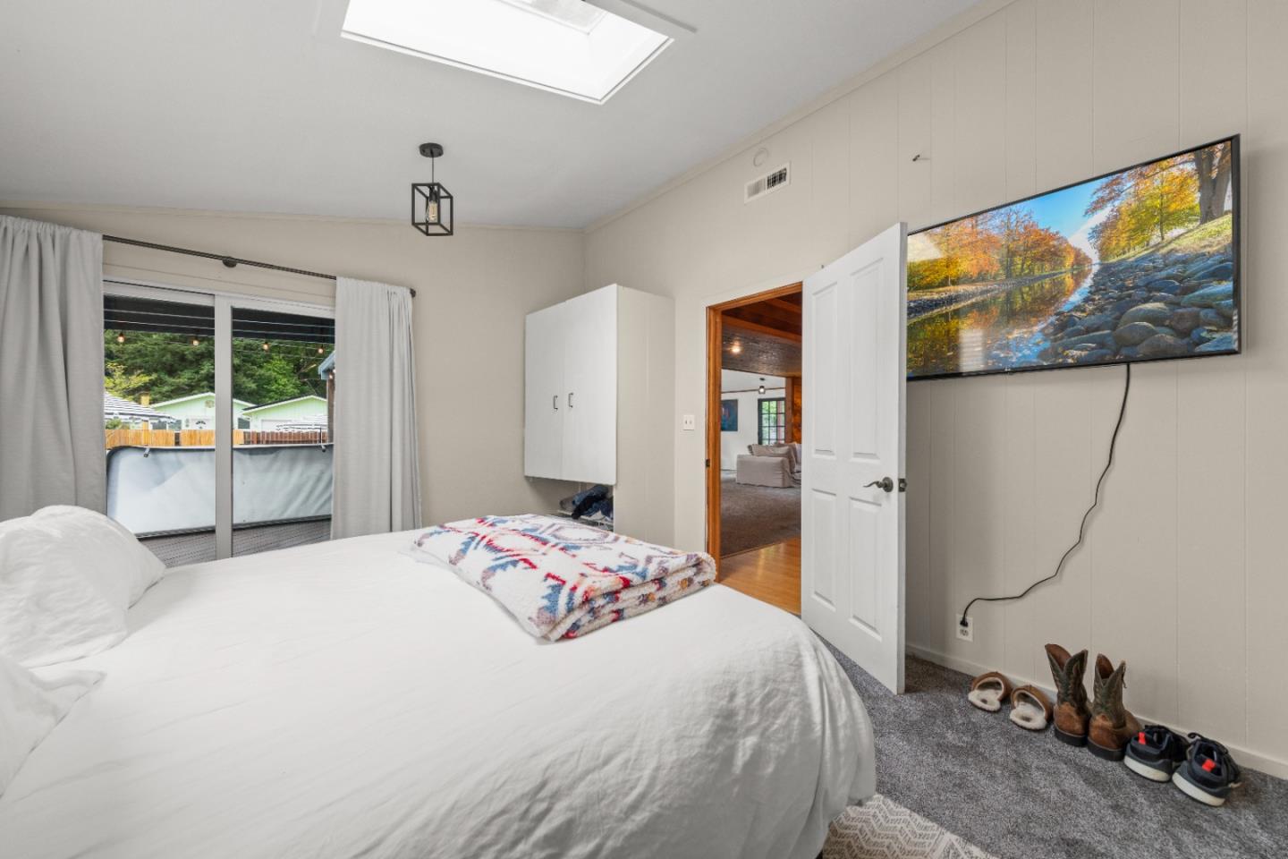 210 Madrona Way Ben Lomond, CA 95005 - Photo 26 of 56 a bedroom with a bed a dresser next to a window