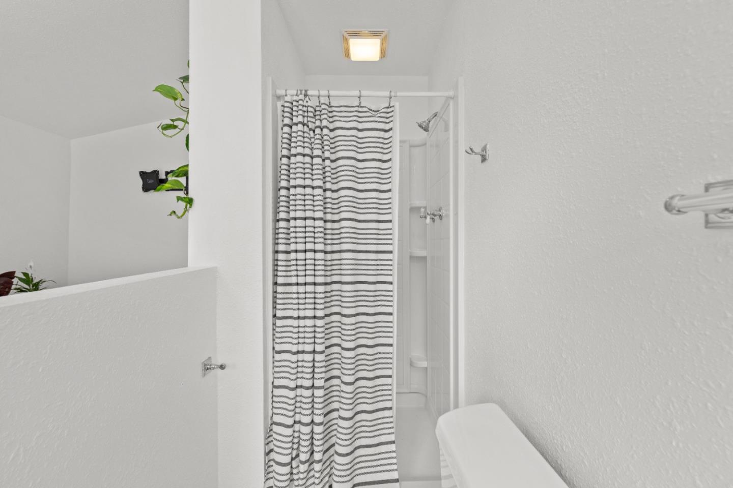 210 Madrona Way Ben Lomond, CA 95005 - Photo 32 of 56 a bathroom with a shower curtain and a toilet